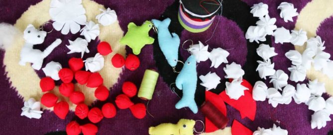 Assortment of handmade character keychains, decorated jars, and craft ornaments