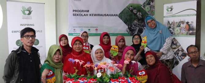 Participants of YIIM creative handicraft training displaying handmade soap floral arrangements