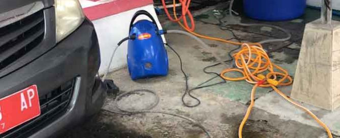 Panut Panuju operating his vehicle-washing business