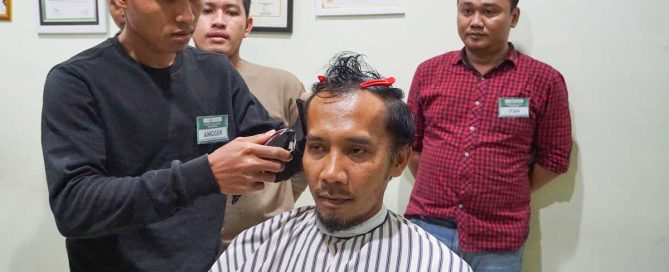 Participants complete hands-on barber training at YIIM
