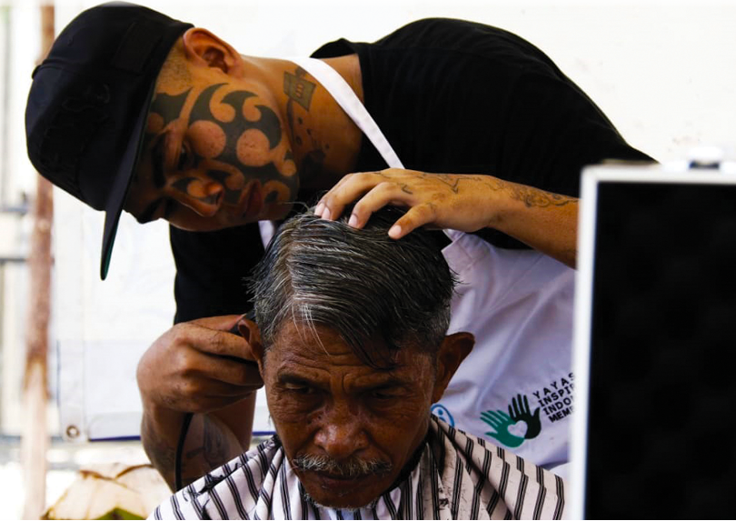 Participant receiving barber skills training